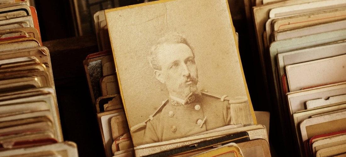 A sepia-toned cabinet photograph depicting a man dressed in a military uniform